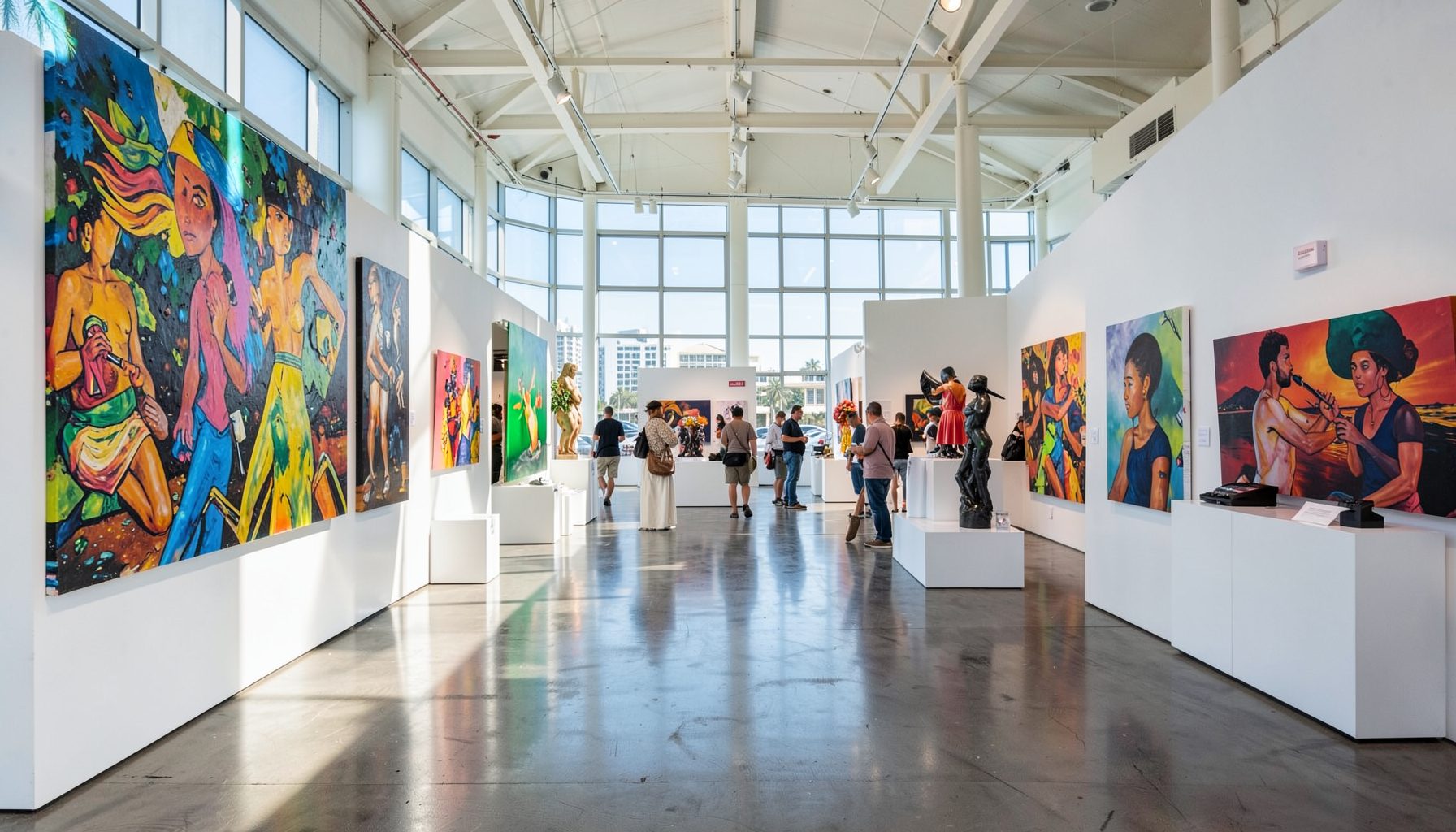 A sun-drenched Miami Beach convention center interior during an art fair, with colorful large-scale paintings and sculpture